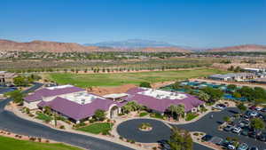 Aerial view of residential area featuring a local golf course and a water and mountain view