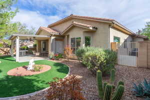 Rear view of house featuring a patio area and stucco siding, beautiful desert plants