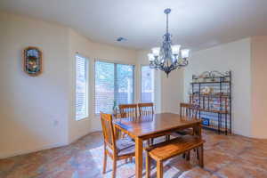 Dining space featuring bay windows and a chandelier