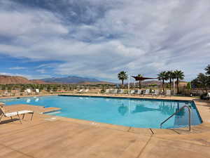 Community pool with a mountain view and a patio area