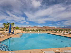 Community pool featuring a mountain view and a patio area at the clubhouse