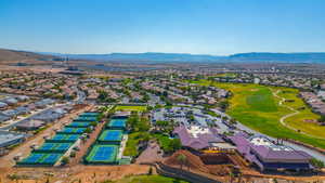 Aerial view of residential area with mountains and a local golf course