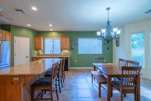 Open kitchen and dining area with large island and breakfast bar area.