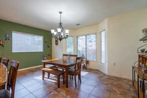 Dining space featuring a chandelier and tile patterned flooring