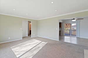 Formal Living  room with ornamental molding, light carpet, recessed lighting