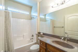 2nd Bathroom with shower / bath combination with curtain and vanity