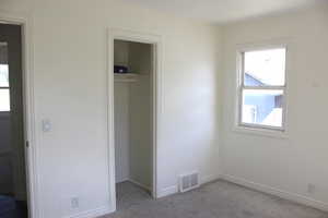 Bedroom featuring carpet floors and a walk in closet