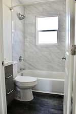 Bathroom with vanity, shower / washtub combination, and dark wood-type flooring