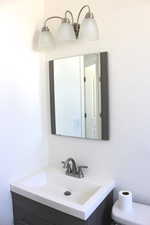 Bathroom with vanity and a textured wall