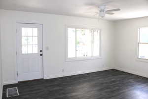 Foyer entrance featuring dark wood-type flooring and a ceiling fan