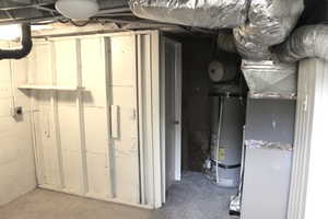 Utility area with water heater and heating unit