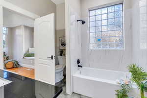 Bathroom featuring shower / tub combo and toilet