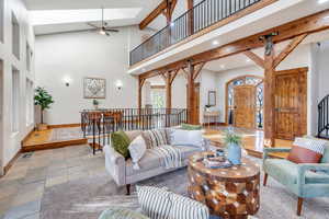 Living area featuring stairway, high vaulted ceiling, recessed lighting, beamed ceiling, and ceiling fan