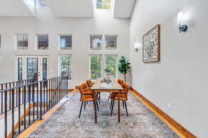 Dining room featuring wood finished floors and a high ceiling
