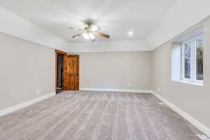 Empty room with light colored carpet, ceiling fan, and recessed lighting