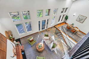 Living room with a towering ceiling and baseboards