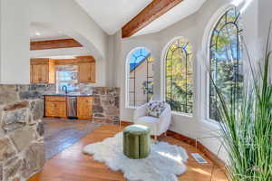 Living area with light wood-type flooring and arched walkways