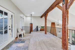 Living area featuring plenty of natural light, carpet flooring, and recessed lighting