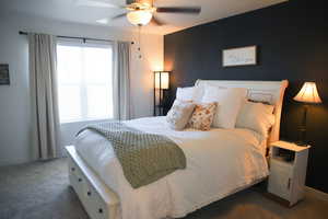 Bedroom featuring dark colored carpet and ceiling fan