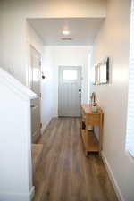 Entryway with baseboards and hardwood / wood-style flooring