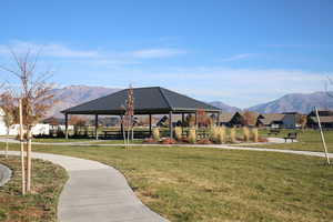 Surrounding community featuring a yard and a mountain view