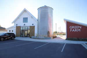 View of property featuring uncovered parking