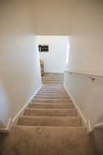 Stairs featuring baseboards and wood finished floors