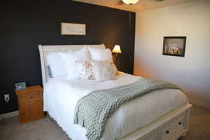 Bedroom with carpet floors and a ceiling fan