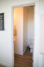 Bathroom with dark wood finished floors and baseboards
