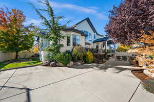Rear view of house featuring stucco siding, a patio, an outdoor hangout area, and stairway