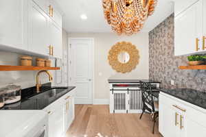 Kitchen featuring white cabinets, open shelves, light wood-style floors, recessed lighting, and wallpapered walls
