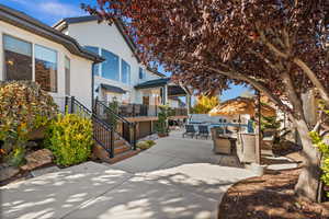 View of patio with stairway, outdoor dining area, outdoor lounge area, and a sunroom