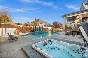 View of swimming pool featuring a patio, a fenced backyard, and ceiling fan