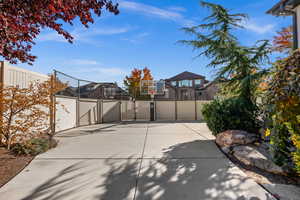 View of patio / terrace featuring basketball hoop and a gate