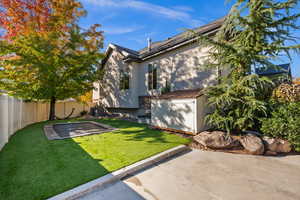 Fenced backyard with a patio and an outbuilding