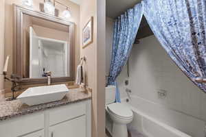 Full bath featuring shower / bathtub combination with curtain and vanity