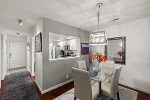 Dining space with dark wood finished floors