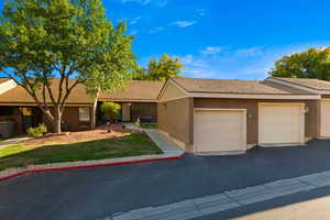Ranch-style house with a shingled roof and a front lawn