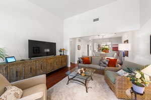 Living room featuring wood finished floors and a towering ceiling