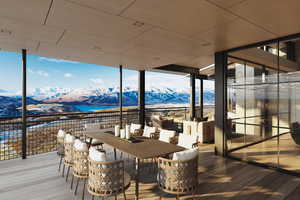 Wooden deck featuring a mountain view and outdoor dining area