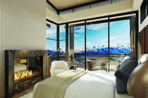 Bedroom with a fireplace, a water and mountain view, multiple windows, and wood finished floors