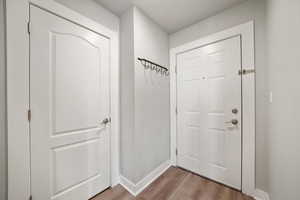 Entryway with wood finished floors and baseboards