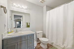 Bathroom featuring vanity and wood finished floors