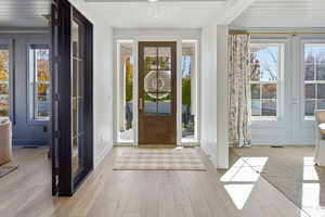 Foyer featuring healthy amount of natural light, hardwood / wood-style flooring, and wood ceiling