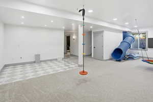 Basement featuring recessed lighting and light carpet