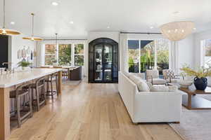 Living room featuring light wood finished floors, recessed lighting, and a chandelier