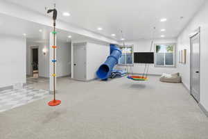 Recreation room with recessed lighting and carpet flooring