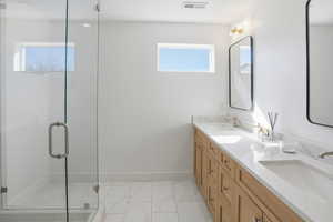 Bathroom with double vanity and a shower stall