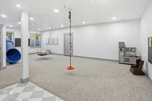 Exercise room featuring recessed lighting and light colored carpet