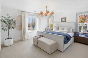 Bedroom with carpet flooring and a chandelier